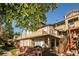 Attractive townhome showcasing manicured landscaping, outdoor staircases, and charming facade at 6001 S Yosemite St # B206, Greenwood Village, CO 80111