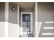 Inviting entryway with decorative security door and modern light fixture at 6001 S Yosemite St # B206, Greenwood Village, CO 80111