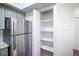 Gourmet kitchen features stainless steel refrigerator and large pantry at 6001 S Yosemite St # B206, Greenwood Village, CO 80111