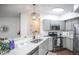 Modern kitchen with stainless appliances, grey cabinetry, and granite countertops at 6001 S Yosemite St # B206, Greenwood Village, CO 80111