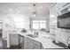Open-concept kitchen area with stainless steel appliances, bar seating, granite countertops, and lots of natural light at 6001 S Yosemite St # B206, Greenwood Village, CO 80111