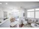 Sun-filled living room with hardwood floors, dining area, and sliding door to balcony at 6001 S Yosemite St # B206, Greenwood Village, CO 80111