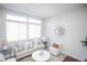 Cozy living room featuring bright natural light, neutral decor, and hardwood floors at 6001 S Yosemite St # B206, Greenwood Village, CO 80111
