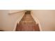 Carpeted staircase with wood flooring at the base, leading to the upper level at 6001 S Yosemite St # B206, Greenwood Village, CO 80111