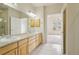 Bathroom featuring double sinks, vanity with drawers, tiled floors, and a doorway at 616 Wild Ridge Cir, Lafayette, CO 80026