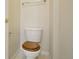 Clean bathroom featuring a toilet with wood seat and towel bar at 616 Wild Ridge Cir, Lafayette, CO 80026