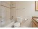 Bathroom featuring a bath tub with tiled walls, toilet, and towel rack at 616 Wild Ridge Cir, Lafayette, CO 80026