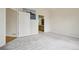 Spacious bedroom featuring neutral walls, carpet, and a view of the adjoining bathroom at 616 Wild Ridge Cir, Lafayette, CO 80026