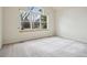 Sunlit bedroom with large window offering lots of natural light and neutral carpet at 616 Wild Ridge Cir, Lafayette, CO 80026