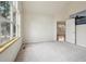 An airy bedroom features a neutral color scheme, carpet, and a door to another room at 616 Wild Ridge Cir, Lafayette, CO 80026