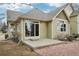 Back exterior of a tan house with a concrete patio, nice roof, and gravel at 616 Wild Ridge Cir, Lafayette, CO 80026