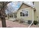 Exterior of a tan home featuring a yard with rocks and a patio at 616 Wild Ridge Cir, Lafayette, CO 80026