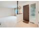 Bright entryway with neutral carpet and a view into the living area at 2497 S Lima Way, Aurora, CO 80014