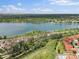 Breathtaking aerial view of homes nestled near a serene lake and lush green landscape at 2468 Channel Dr, Highlands Ranch, CO 80129