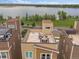 Great aerial view of townhome roof top decks with lake backdrop at 2468 Channel Dr, Highlands Ranch, CO 80129