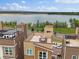 Stunning aerial view of rooftop patios, with lake backdrop, perfect for entertaining at 2468 Channel Dr, Highlands Ranch, CO 80129