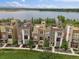 Attractive townhouse exterior with modern design, balconies, and well-kept landscaping near a lake at 2468 Channel Dr, Highlands Ranch, CO 80129