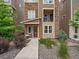 Multi-level townhouse showcasing modern architecture, stone accents, and a charming entrance at 2468 Channel Dr, Highlands Ranch, CO 80129