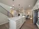 Spacious kitchen features an island with barstool seating and flows into the living area at 2468 Channel Dr, Highlands Ranch, CO 80129