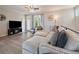 Comfortable living area with a large sectional couch, modern furnishings, and an electric fireplace at 2468 Channel Dr, Highlands Ranch, CO 80129