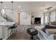 Open concept living room with modern furnishings flowing into the kitchen area at 2468 Channel Dr, Highlands Ranch, CO 80129