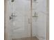 Modern shower with glass doors, white marble tile and grey, honeycomb tile floors at 2468 Channel Dr, Highlands Ranch, CO 80129