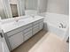 Bathroom with double vanity, soaking tub, and tile flooring at 14948 E Belleview Ave, Aurora, CO 80015