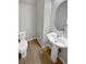 Clean bathroom with pedestal sink and a toilet at 14948 E Belleview Ave, Aurora, CO 80015