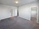 Spacious bedroom with gray carpet and an attached bathroom at 14948 E Belleview Ave, Aurora, CO 80015