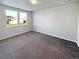 Bright bedroom featuring two large windows and plush carpeting at 14948 E Belleview Ave, Aurora, CO 80015