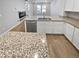 Island kitchen with granite countertops and stainless steel appliances at 14948 E Belleview Ave, Aurora, CO 80015