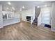 Open concept living area with hardwood floors and kitchen island at 14948 E Belleview Ave, Aurora, CO 80015
