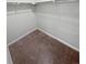 Spacious walk-in closet with double hanging rods and carpeted floor at 14948 E Belleview Ave, Aurora, CO 80015