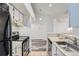 Clean kitchen with modern appliances, with a breakfast bar overlooking the open layout at 4760 S Wadsworth Blvd # M302, Littleton, CO 80123