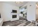 Bright living room features a brick fireplace and steps up to the kitchen with an open floor plan at 4760 S Wadsworth Blvd # M302, Littleton, CO 80123