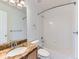Well-lit bathroom with granite countertop, a large mirror, and shower-tub combination at 13472 Columbine Cir, Thornton, CO 80241