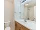 Bathroom with wood vanity, large mirror and shower-tub combination at 13472 Columbine Cir, Thornton, CO 80241