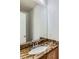 Bathroom vanity with granite countertop, large mirror, and plenty of natural light at 13472 Columbine Cir, Thornton, CO 80241