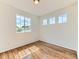 Bright room featuring hardwood floors and three windows for lots of natural light at 13472 Columbine Cir, Thornton, CO 80241