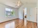 Bedroom with vaulted ceiling, large window providing views, and hardwood floors at 13472 Columbine Cir, Thornton, CO 80241