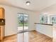 Bright dining area with wood floors, sliding glass doors to the deck, and views of the backyard at 13472 Columbine Cir, Thornton, CO 80241