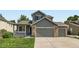 Charming home featuring a well-manicured lawn, covered porch, and two-car garage at 13472 Columbine Cir, Thornton, CO 80241
