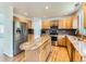 Modern kitchen with wooden cabinets, granite countertops, and stainless steel appliances at 13472 Columbine Cir, Thornton, CO 80241
