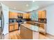 Modern kitchen featuring wooden cabinets, granite countertops, and stainless steel appliances at 13472 Columbine Cir, Thornton, CO 80241