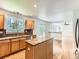 Modern kitchen featuring wooden cabinets, granite countertops, and a center island at 13472 Columbine Cir, Thornton, CO 80241