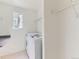 Well-lit laundry room with modern washer and dryer, and built in shelving for organization at 13472 Columbine Cir, Thornton, CO 80241