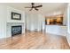 Spacious living room featuring a cozy fireplace, beautiful hardwood floors, and ample natural light at 13472 Columbine Cir, Thornton, CO 80241