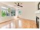 Bright living room with large windows offering a view and hardwood floors at 13472 Columbine Cir, Thornton, CO 80241