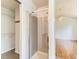 Bathroom shower with glass door, tile surround, and closet space at 13472 Columbine Cir, Thornton, CO 80241