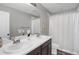 Bathroom with double sinks and a shower/tub combo at 2523 Villageview Ln, Castle Rock, CO 80104